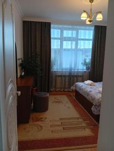 a bedroom with a bed and a large window at Shahdag Beloved Home in Qusar +25 photos