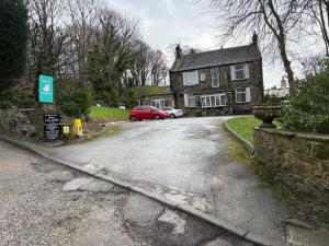 a red car parked in front of a house at Peasehill StMichaels in Rawdon