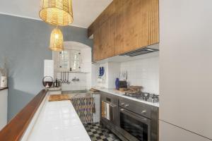 a kitchen with a sink and a stove at Casa Anita - Storia & Mare in Zoagli