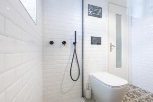a white bathroom with a toilet and a shower at Casa Anita - Storia & Mare in Zoagli +47 photos