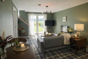 a living room with a couch and a table at Friars Carse Country House Hotel in Dumfries