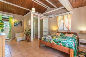 a bedroom with a bed in a room at Gîte Dalina Sainte-Rose in Sainte-Rose +73 photos