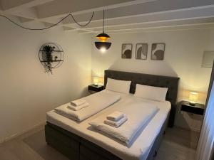 a bedroom with a bed with towels on it at 2-Zimmer Souterrain Wohnung in Kehl am Rhein
