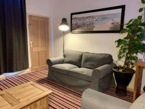a living room with a couch and a potted plant at The Waterfront Lodges in Coventry