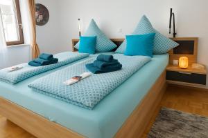 a large blue bed with blue pillows on it at Merziger Fußgängerzone in Merzig