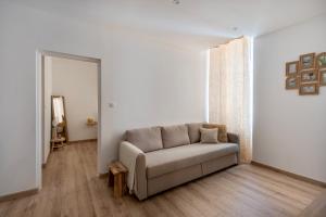 a living room with a couch and a mirror at L'escale Mourillon - Plage, Balnéo & Soleil in Toulon +11 photos