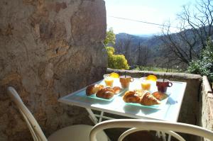 a table with croissants and glasses of orange juice at Le Mazet d'Aurore in Chassiers +51 photos