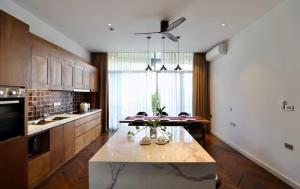 a large kitchen with a table and a large window at Levallois luxure in Levallois-Perret