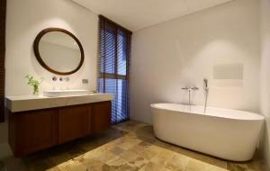 a bathroom with a tub and a sink and a mirror at Levallois luxure in Levallois-Perret