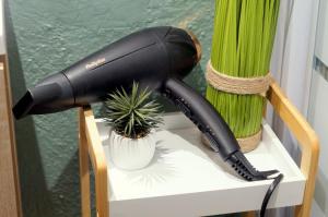 a blow dryer on a stand next to a plant at Le Mazet d'Aurore in Chassiers