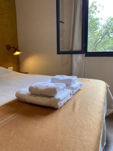 two towels sitting on top of a bed at Color Local Cabañas in San Javier +51 photos