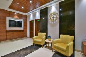 a lobby with two chairs and a tv at SureStay by Best Western Heritage Walk in Amritsar