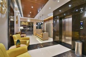 a lobby with yellow chairs and a waiting room at SureStay by Best Western Heritage Walk in Amritsar