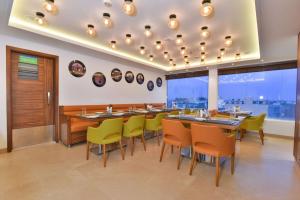 a restaurant with tables and chairs and a large window at SureStay by Best Western Heritage Walk in Amritsar +77 photos