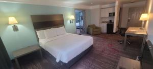 a bedroom with a large white bed in a room at Kemah Edgewater Hotel, SureStay Collection by Best Western in Seabrook