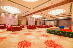 a large banquet hall with red chairs and tables at Best Western Plus Chandigarh Mohali in Mohali