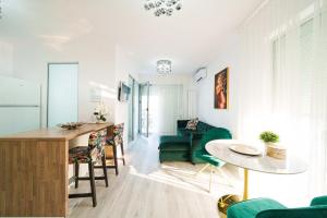 a living room with a table and a green couch at Smile Apartments in Bucharest