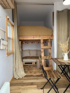 a bunk bed in a room with a chair at Les Cabanes du Cap in Miquelon