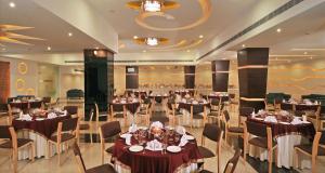 a banquet hall with tables and chairs in a room at Best Western Maryland in Chandīgarh