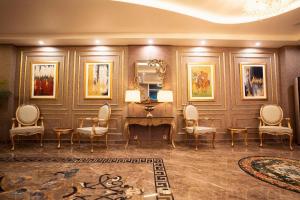 a room with a desk and chairs and a mirror at Best Western Faisalabad in Faisalabad