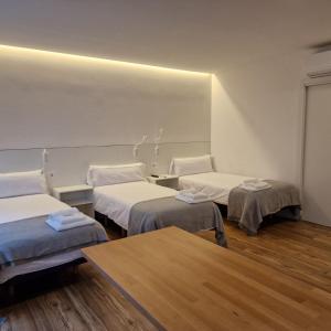 a hospital room with two beds and a table at Alojamientos Cando in Porriño