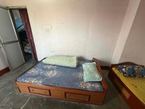 a room with two beds in a room with a door at Hotel Moonlight and Lodge in Birtamod