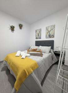 a bedroom with a bed with a yellow blanket on it at El nido in Villarcayo