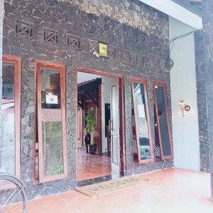 a stone wall with mirrors on the side of a building at Palagan Boutique Hotel in Ngaglik