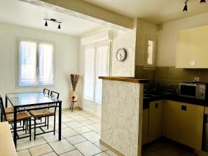 a kitchen with a table and a dining room at "L'olivier" - Résidence Rive Gauche in Les Salles-sur-Verdon