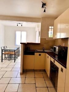 a kitchen with a table and a counter top at "L'olivier" - Résidence Rive Gauche in Les Salles-sur-Verdon
