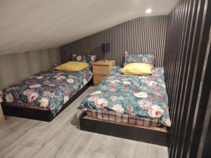 a bedroom with two twin beds and a night stand at Tramway Apartment in Blessington