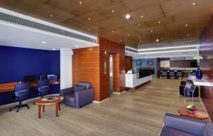 an office with blue walls and chairs and a table at Best Western Alkapuri, Vadodara in Vadodara