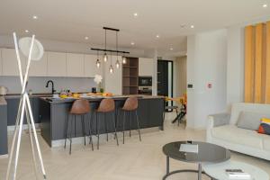 a kitchen and living room with a kitchen island with bar stools at Ocean View Villa, Private Pool and Terrace in Santa Cruz