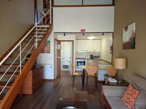 a living room with a staircase leading to a kitchen at Clube Pinhal da Foz in Esposende