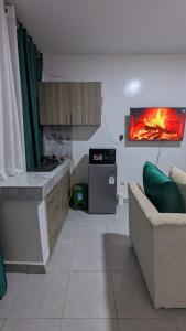 a kitchen with a stove and a couch in a room at Imperial cabins in Nyeri