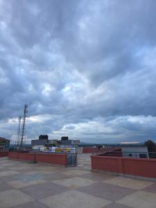 a cloudy sky over a building on a roof at Imperial cabins in Nyeri