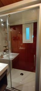 a bathroom with a glass shower with a sink at Le petit chalet des Vosges proche Gerardmer in Corcieux +16 photos