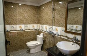 a bathroom with a toilet and a sink at Bản Mận Retreat in Sapa +121 photos