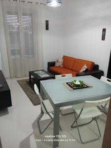 a living room with a table and a couch at Vico Girone in Patti