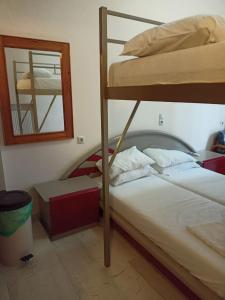 a bedroom with two bunk beds and a mirror at Constantinos Budget Beds in Chania