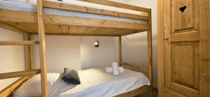 a bedroom with two bunk beds and a door at Les Chalets d'Offaz - Centre Abondance - Alp'in C in Abondance