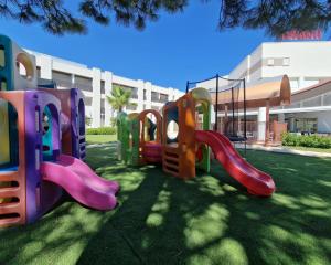 a playground in front of a building at Ashanti Aparthotel Wellness&Spa in Bibione