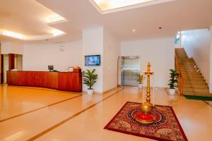 a lobby with a reception desk and a rug on the floor at Periyar Meadows Leisure Hotel in Thekkady