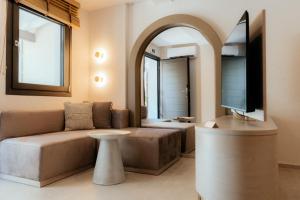 a living room with a couch and a tv at Filakas in Syvota