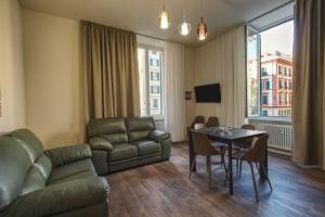 a living room with a couch and a table at Le Due Piazze in Genoa
