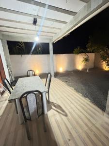 a table and chairs on a patio at night at Refúgio do Mar in Ilhéus