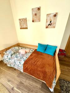 a bedroom with a bed with blue pillows at Charming Cozy Retreat - Terrace & Private Balcony in Coimbra