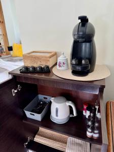 a coffee maker sitting on top of a shelf at Charming Cozy Retreat - Terrace & Private Balcony in Coimbra