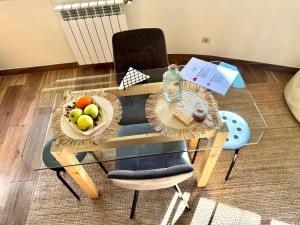 a table and chairs with a bowl of fruit on it at Charming Cozy Retreat - Terrace & Private Balcony in Coimbra