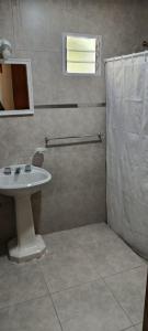 a bathroom with a sink and a shower at Glamaué 2 in Carhué